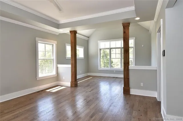 a view of room with window and wooden floor