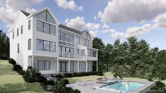 a front view of a house with garden and trees