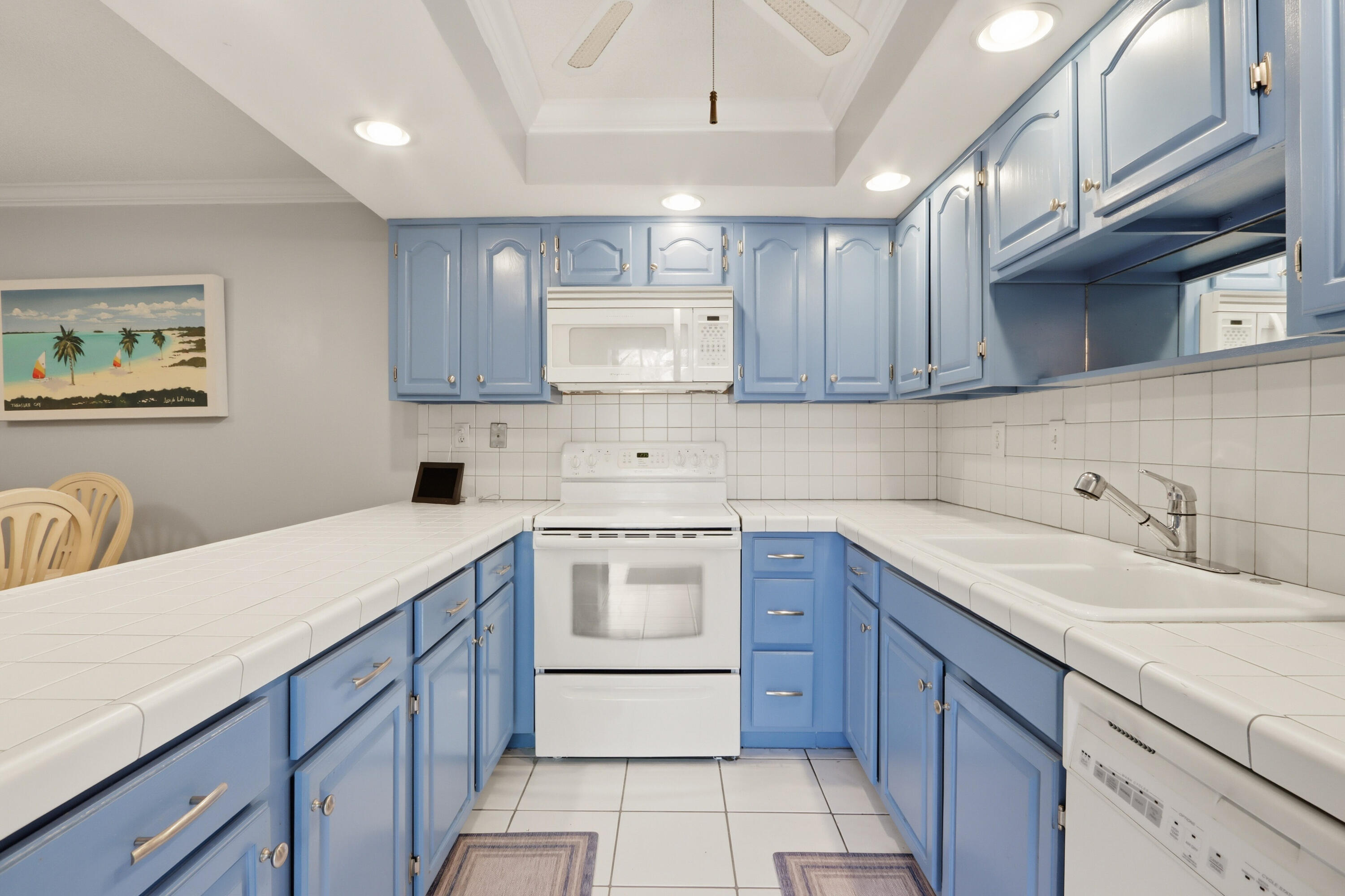 9 Atrium Circle, Unit C Atlantis, FL 33462 - Photo 13 of 54 a kitchen with a sink stove and cabinets