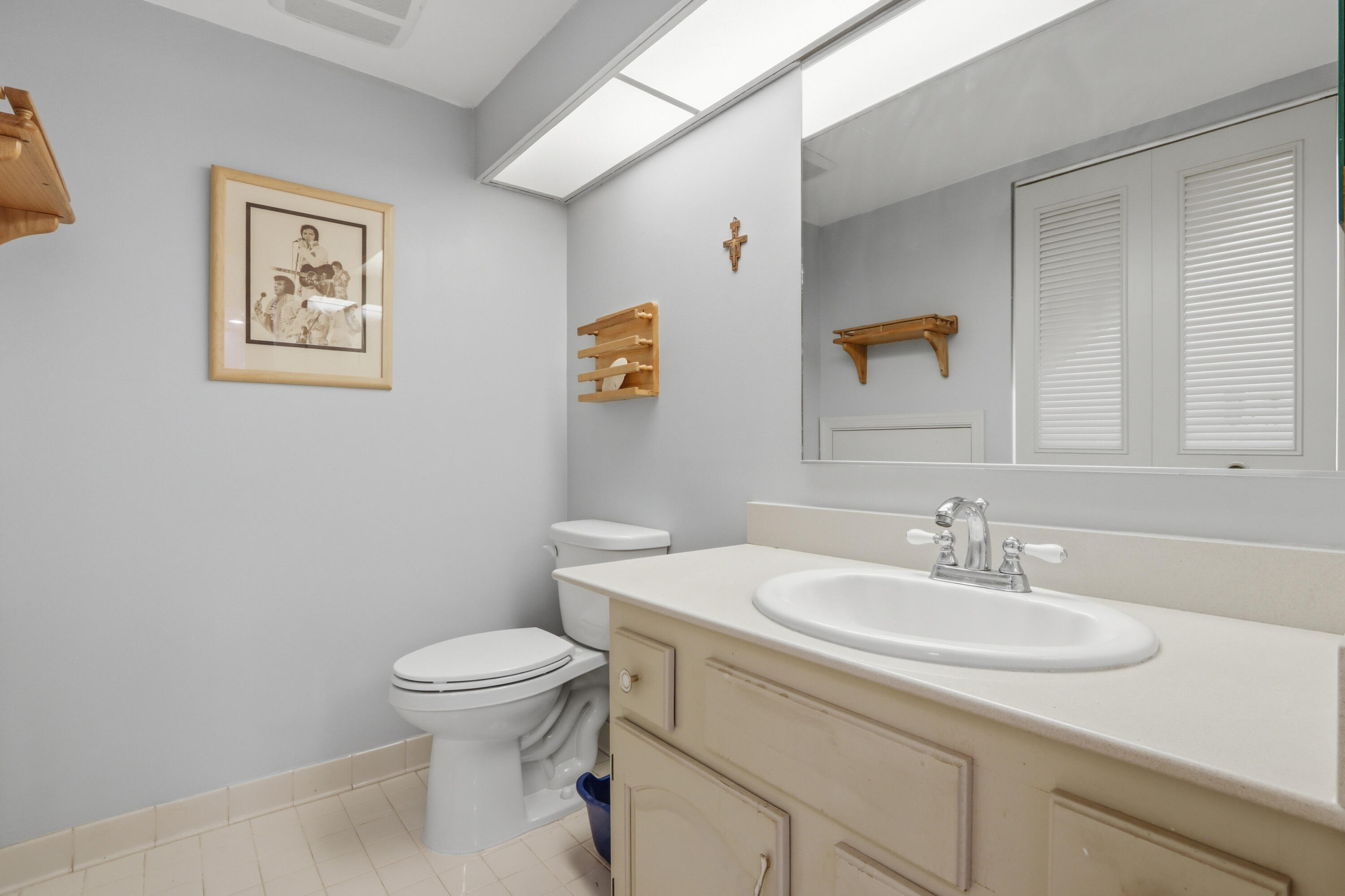 9 Atrium Circle, Unit C Atlantis, FL 33462 - Photo 19 of 54 a bathroom with a sink toilet and vanity