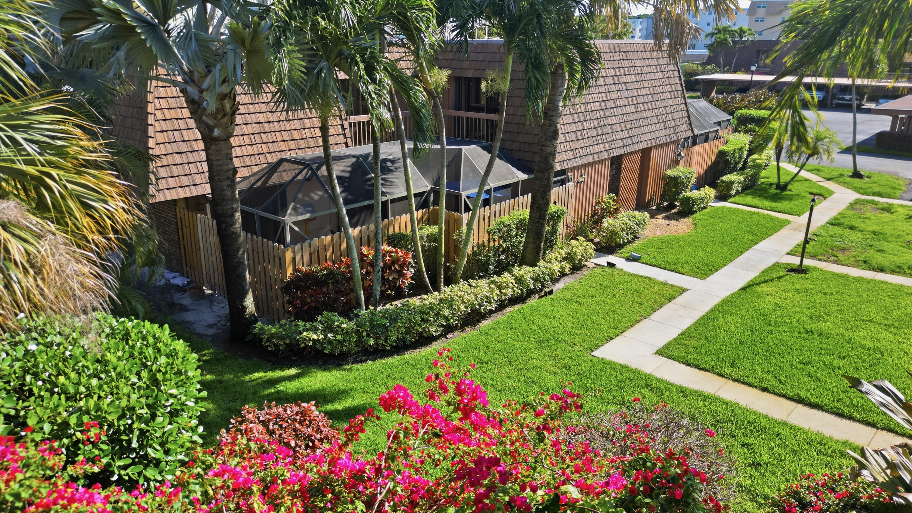 9 Atrium Circle, Unit C Atlantis, FL 33462 - Photo 2 of 54 a view of a chair and table in the garden