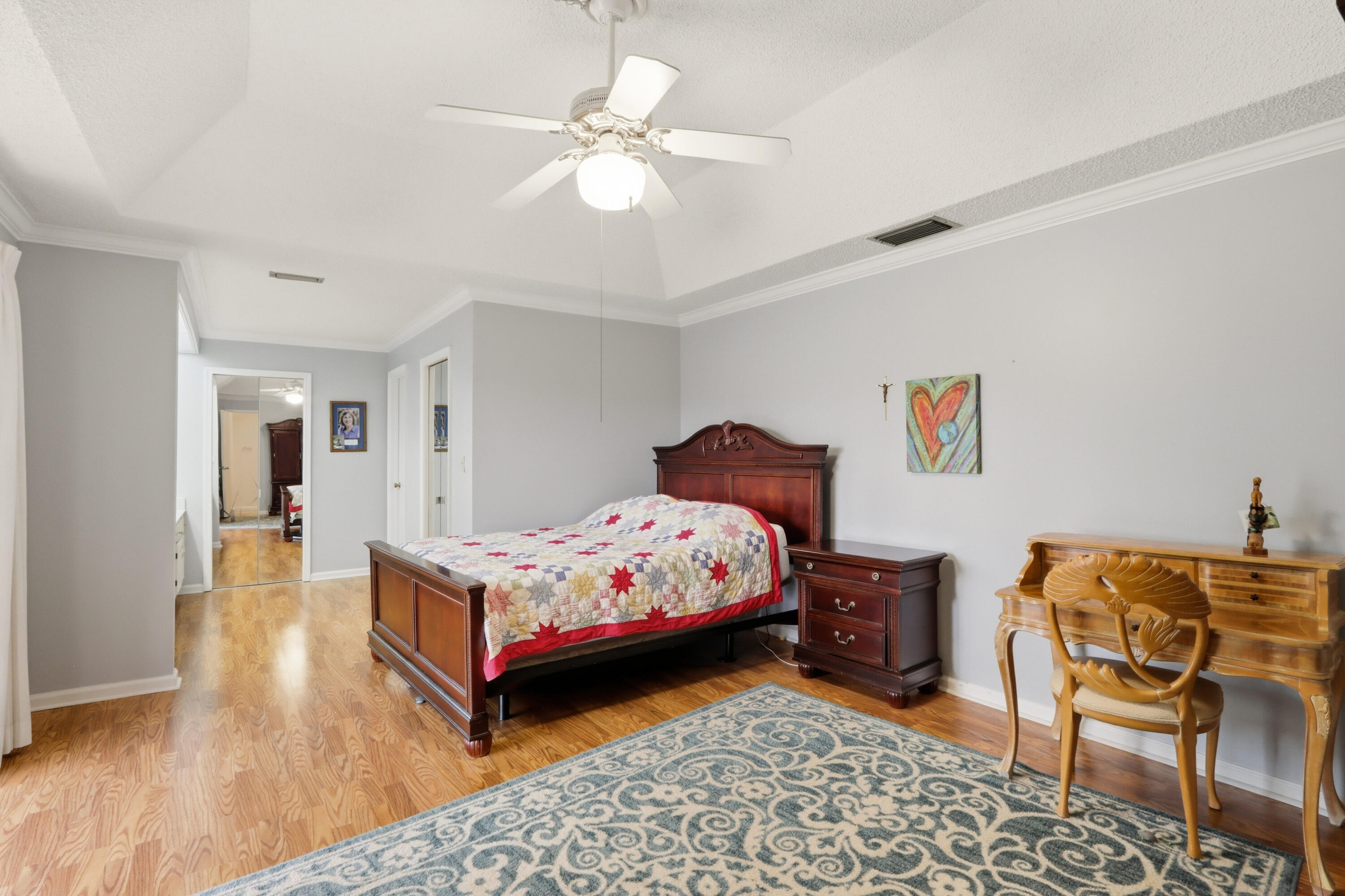 9 Atrium Circle, Unit C Atlantis, FL 33462 - Photo 21 of 54 a bedroom with a bed and wooden floor