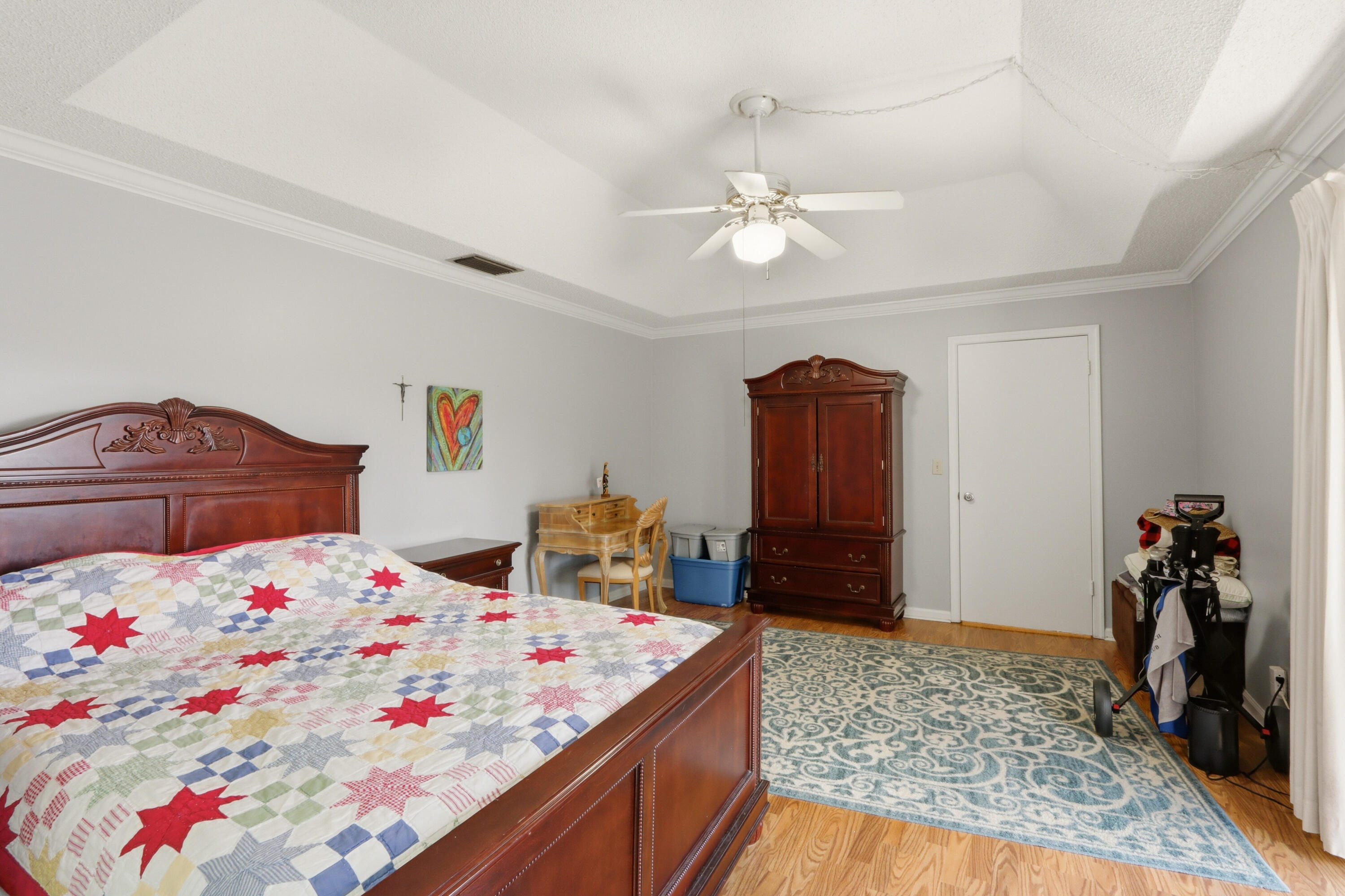 9 Atrium Circle, Unit C Atlantis, FL 33462 - Photo 23 of 54 a bedroom with a bed and wooden floor