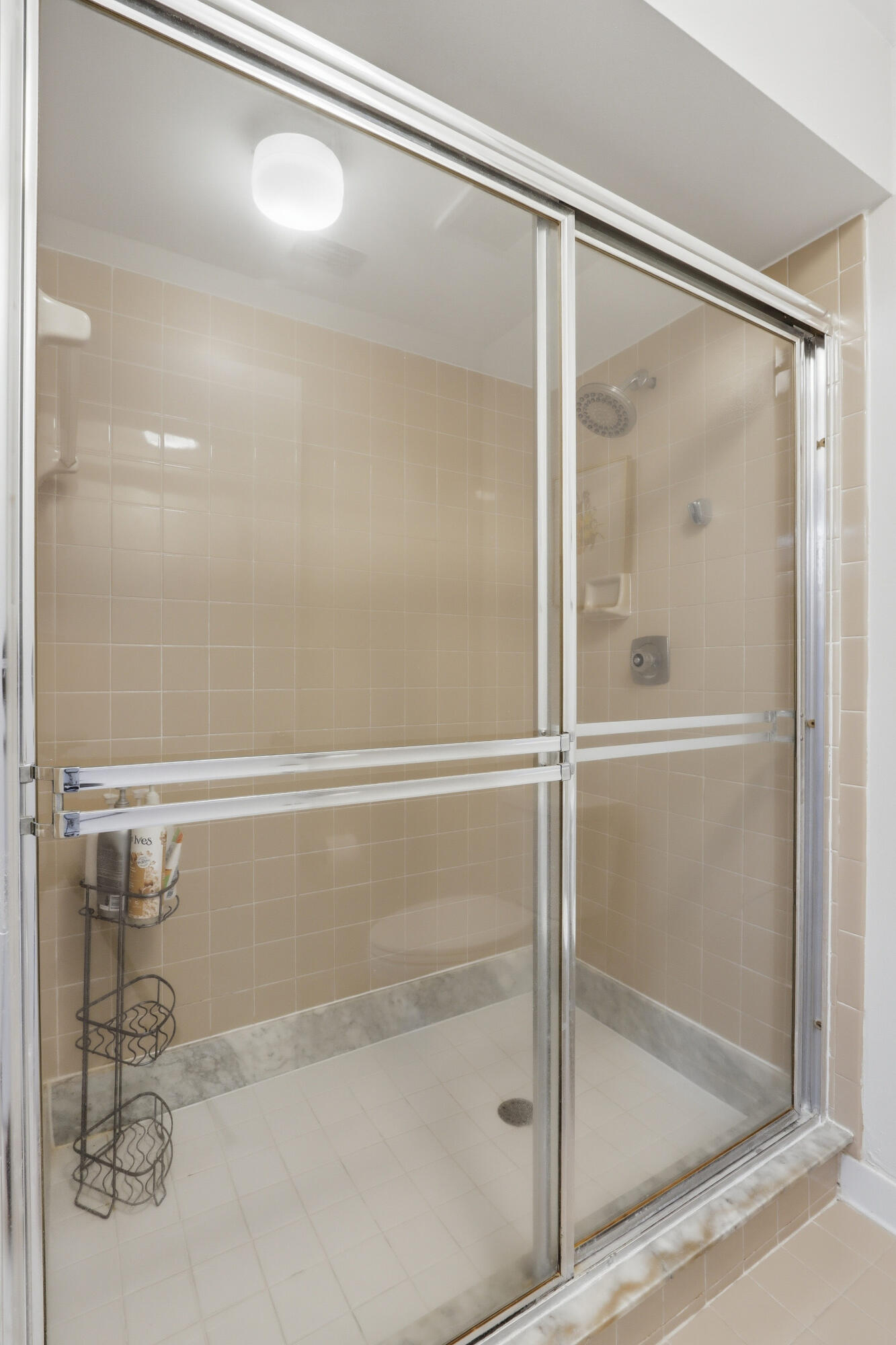 9 Atrium Circle, Unit C Atlantis, FL 33462 - Photo 30 of 54 a bathroom with a glass shower door