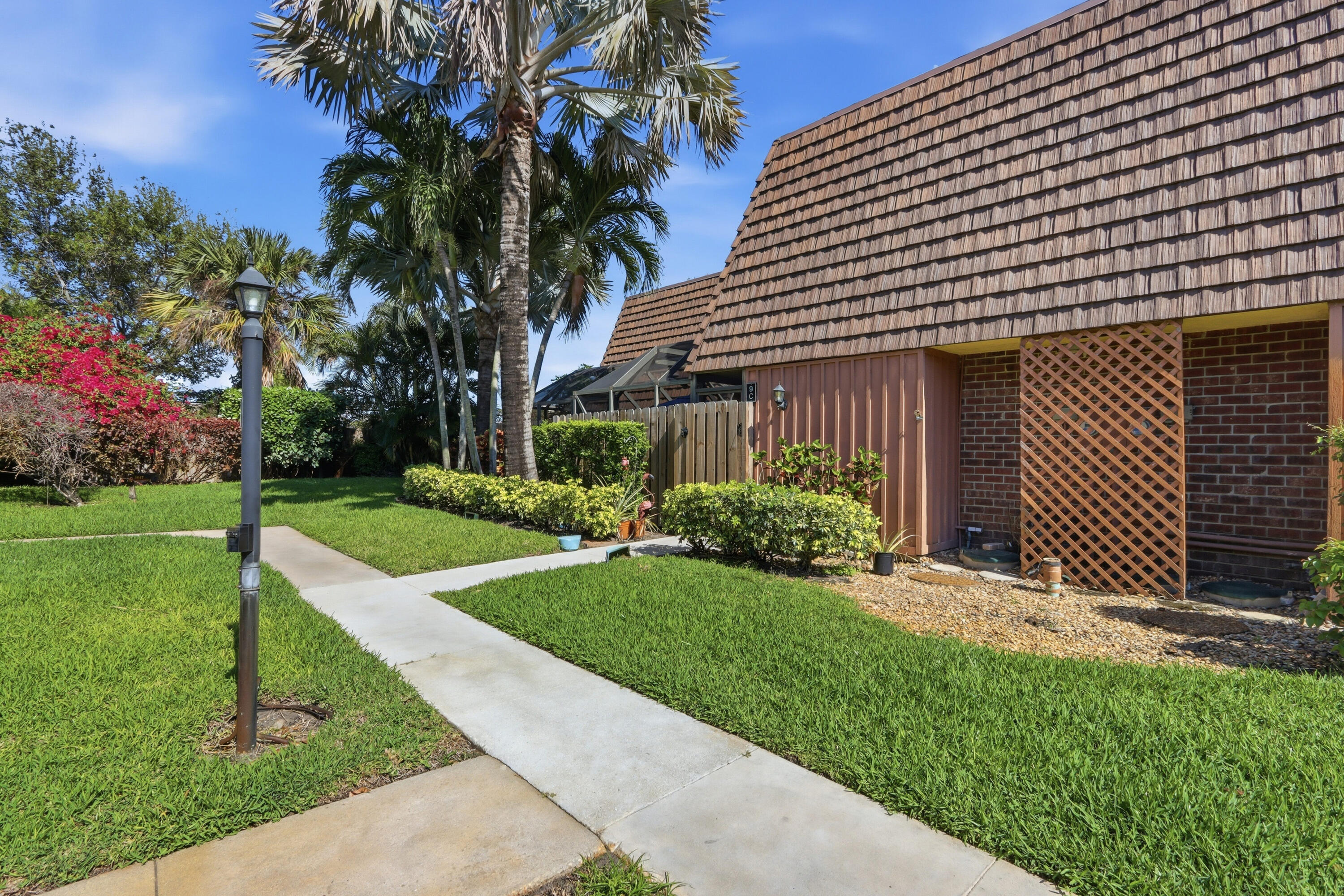 9 Atrium Circle, Unit C Atlantis, FL 33462 - Photo 32 of 54 a front view of a house with a yard