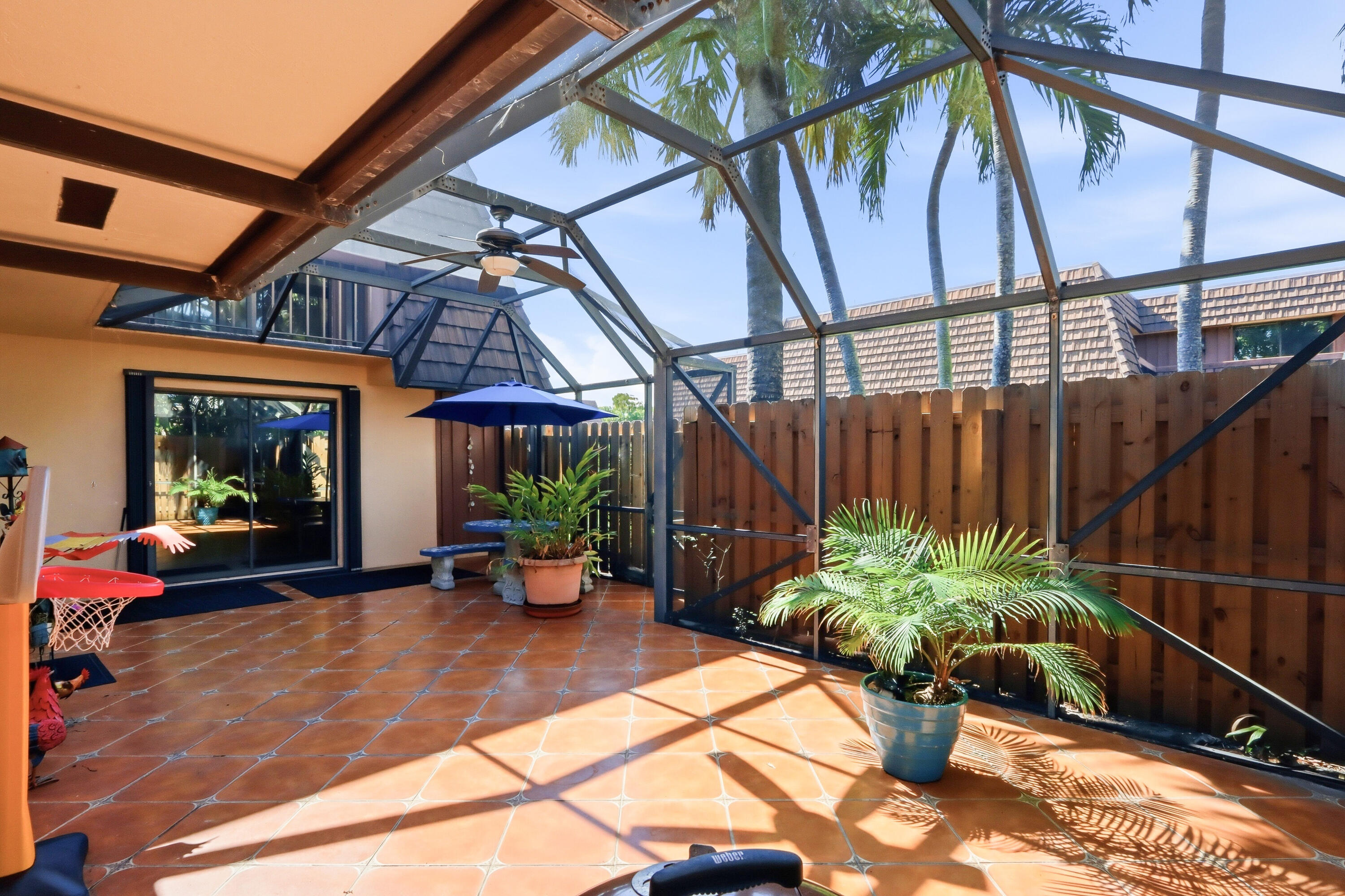 9 Atrium Circle, Unit C Atlantis, FL 33462 - Photo 33 of 54 a view of a chairs and table in the patio