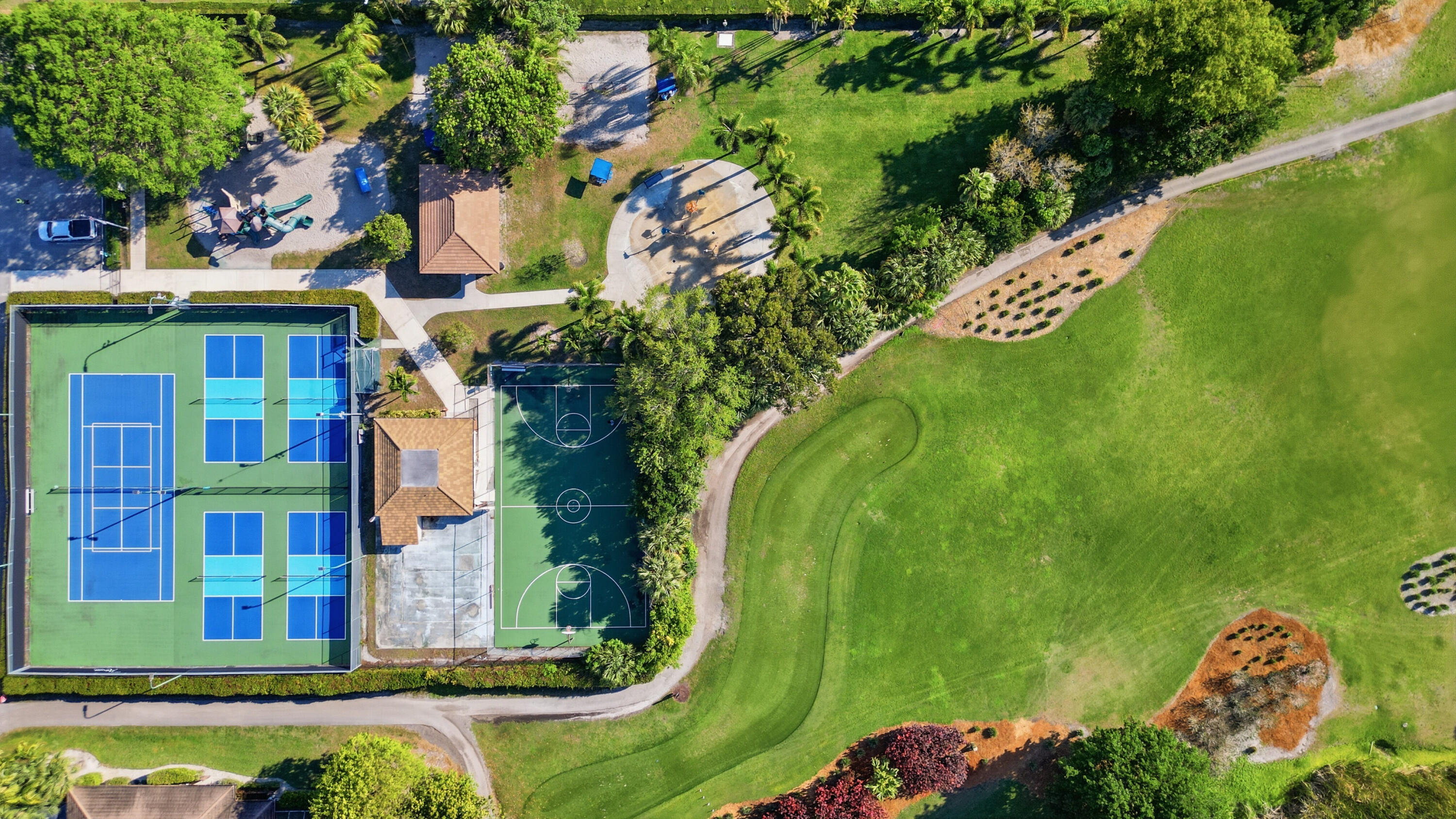 9 Atrium Circle, Unit C Atlantis, FL 33462 - Photo 40 of 54 an aerial view of a house with swimming pool and garden