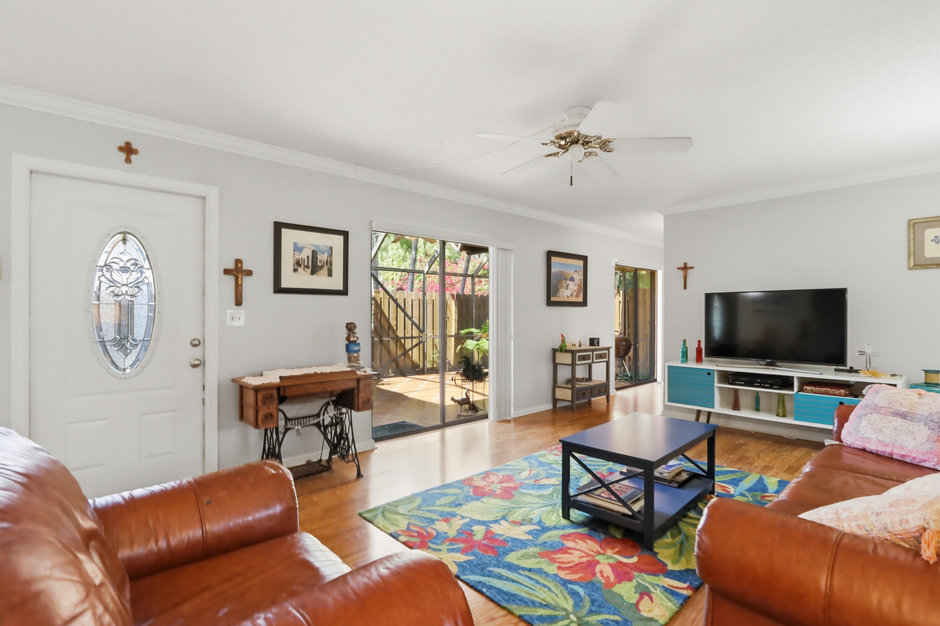 9 Atrium Circle, Unit C Atlantis, FL 33462 - Photo 5 of 54 a living room with furniture a rug and a flat screen tv