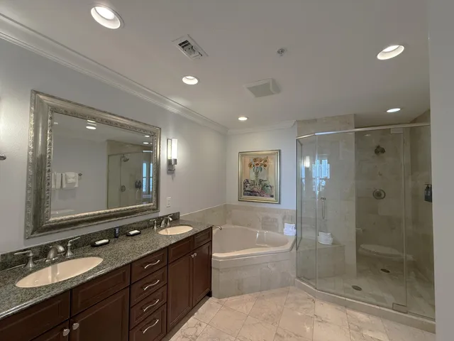 a bathroom with a bath tub sink mirror and shower
