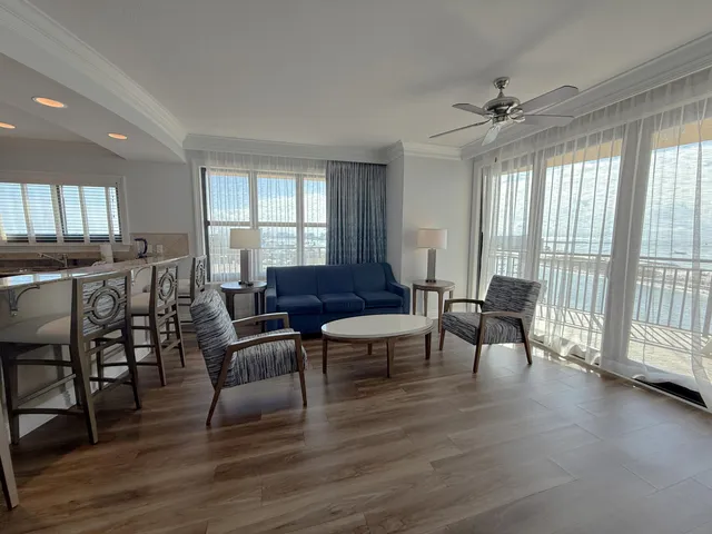 a living room with furniture wooden floor and a window