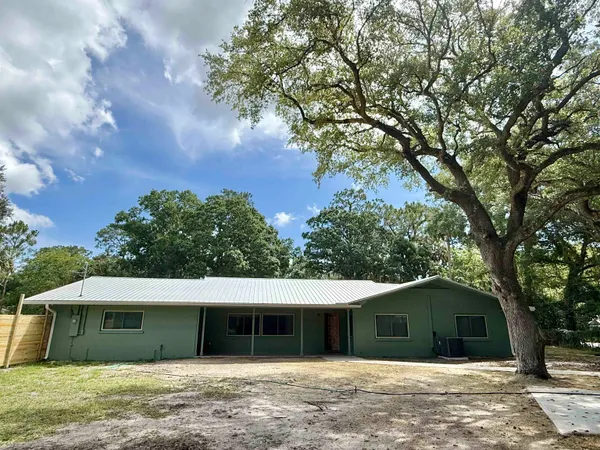 a house with trees in the background