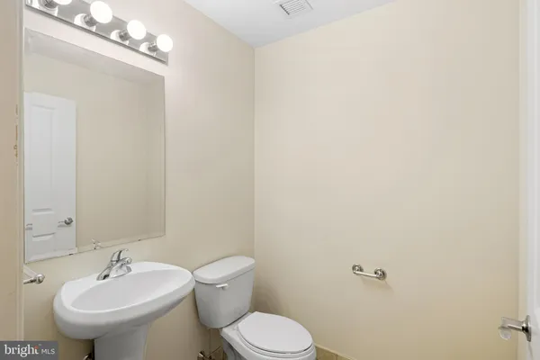 a bathroom with a sink mirror and toilet