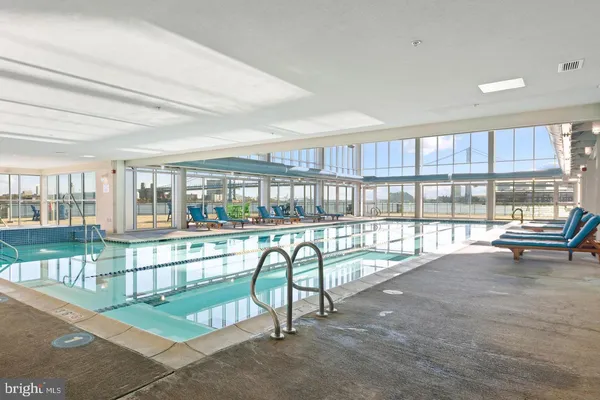 a view of a swimming pool with outdoor seating