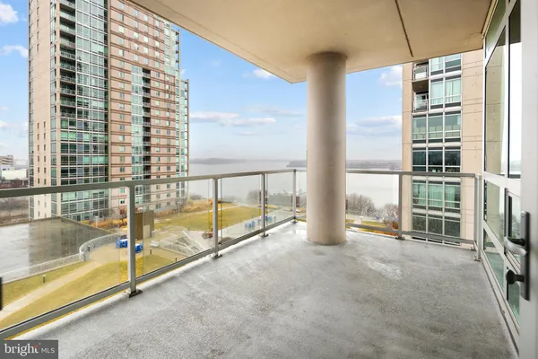 a view of an empty room with floor to ceiling windows