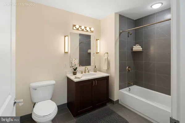a bathroom with a toilet a sink and bathtub