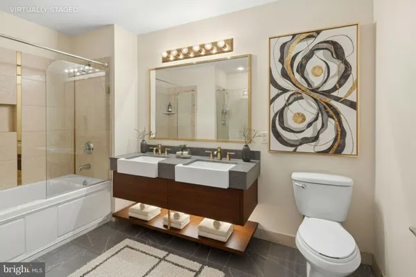 a bathroom with a toilet sink and mirror