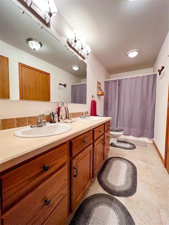 201 Youkers Road Butler, PA 16001 - Photo 16 of 25 a bathroom with a granite countertop sink a mirror and vanity