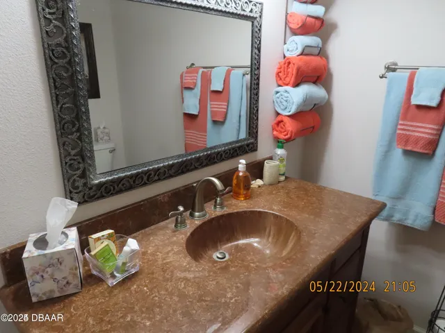 a bathroom with a sink mirror and vanity