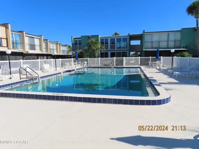 a view of swimming pool with outdoor seating