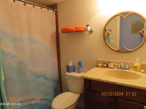 a bathroom with a sink mirror vanity and toilet