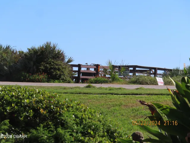 a view of a garden with a building in the background