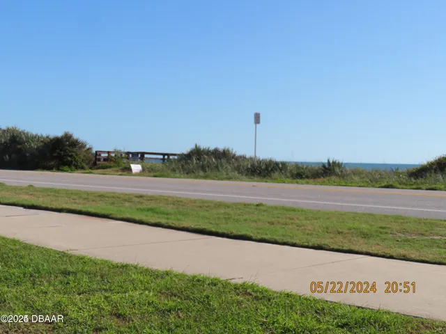 a view of a field with a lake view