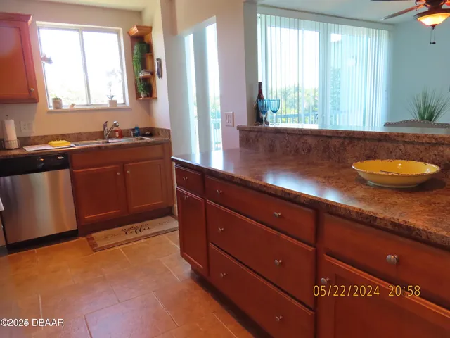 a kitchen with granite countertop cabinets and window