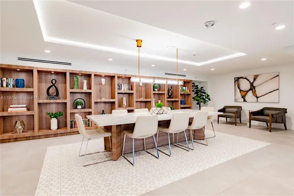 a dining room with stainless steel appliances kitchen island a table and chairs