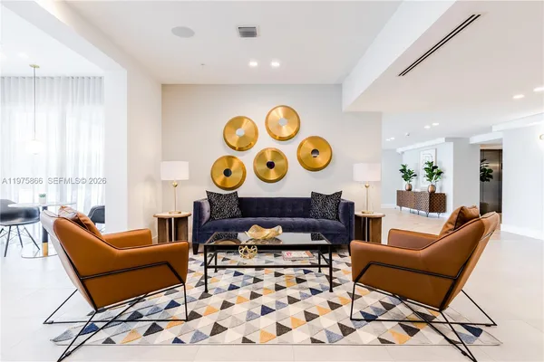 a living room with furniture and a lamp