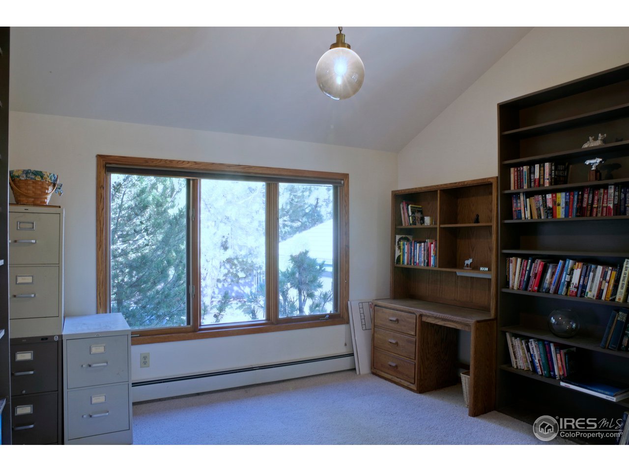 6220 Old Brompton Road Boulder, CO 80301 - Photo 15 of 25 a living room with furniture flat screen tv and a bookshelf