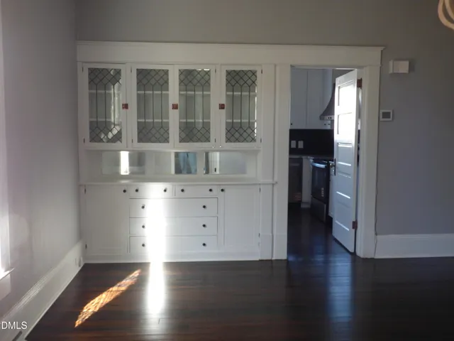 a bathroom with a tub a sink and a large mirror