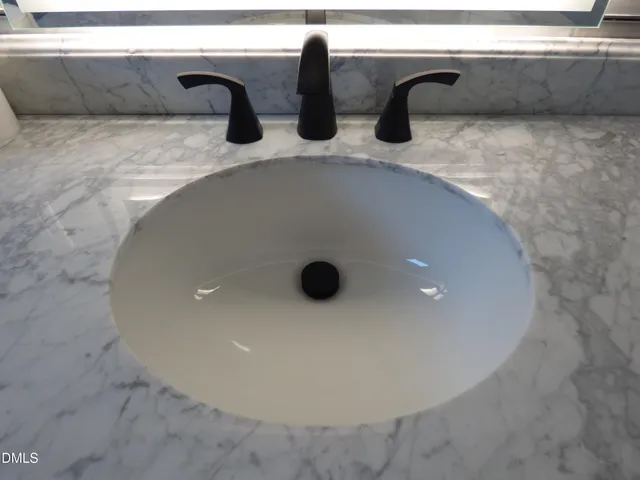 a view of a chandelier fan and a refrigerator