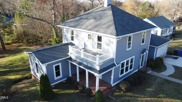 a front view of house with a garden