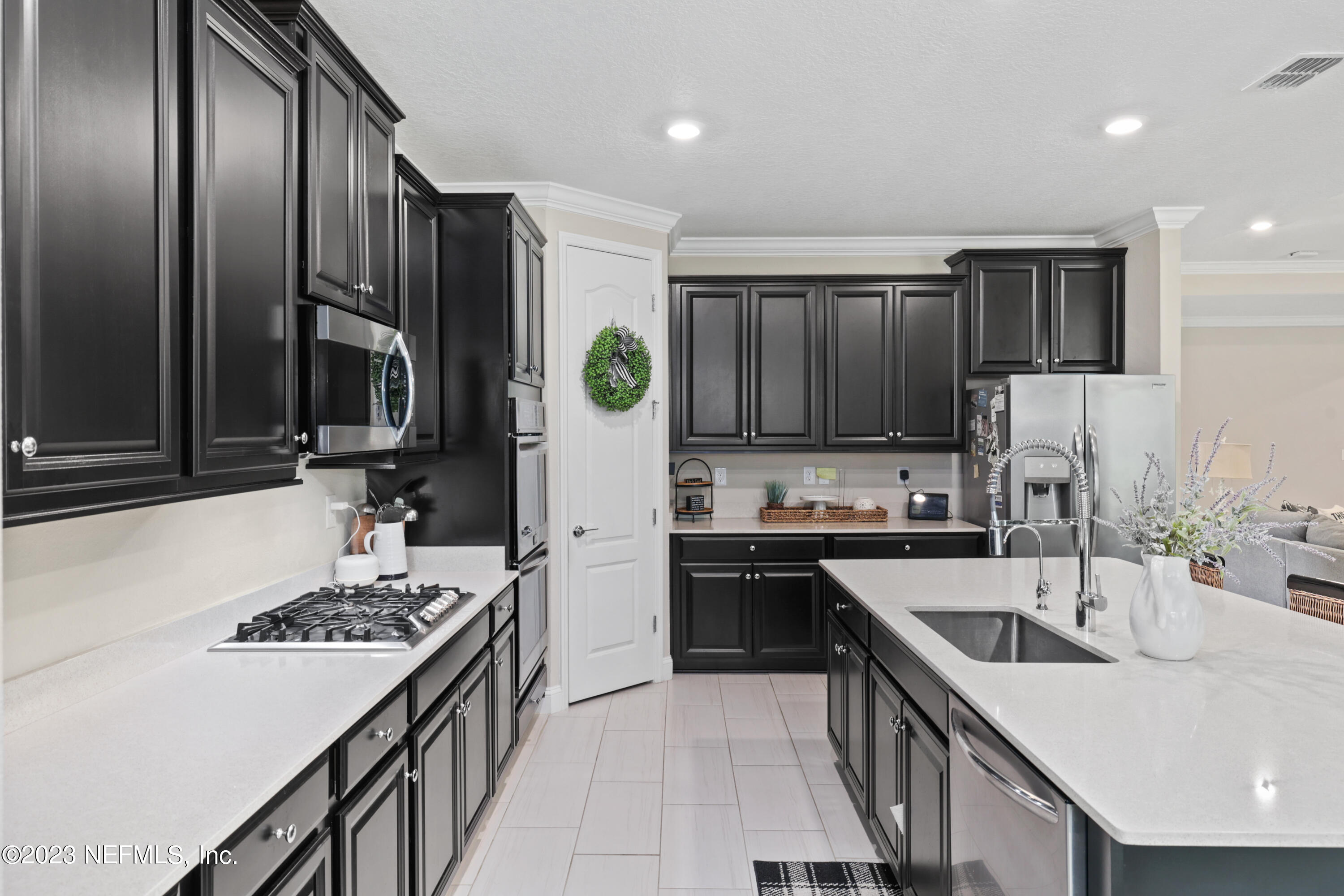 370 Coco Point St. Augustine, FL 32092 - Photo 11 of 48 a kitchen with stainless steel appliances granite countertop a sink stove and refrigerator