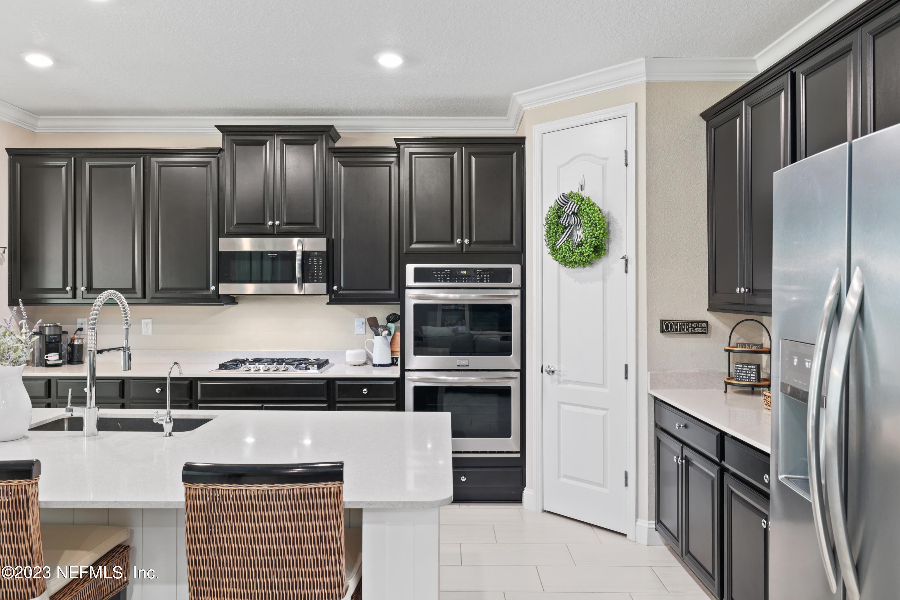 370 Coco Point St. Augustine, FL 32092 - Photo 13 of 48 a kitchen with stainless steel appliances granite countertop a refrigerator and a stove top oven