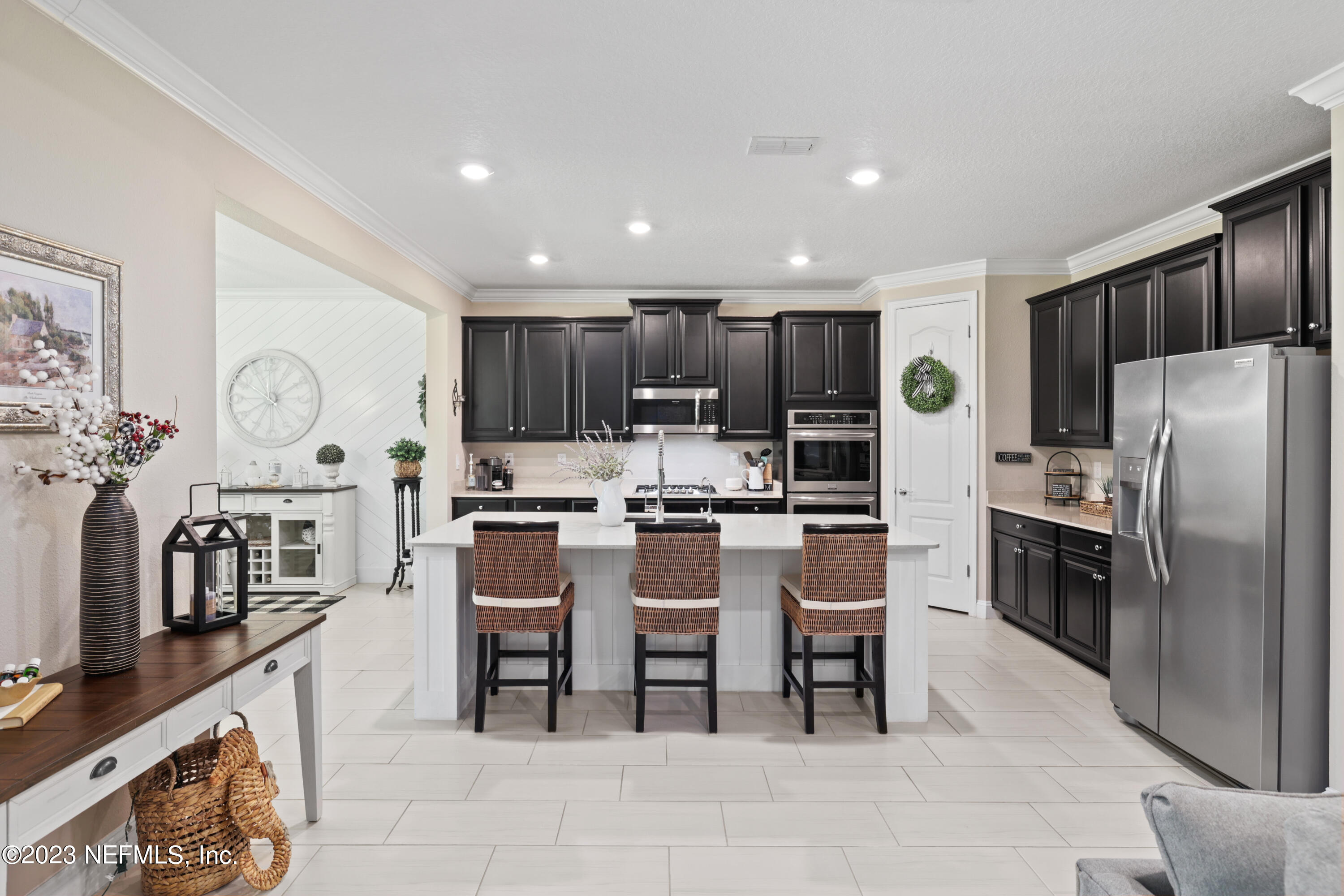 370 Coco Point St. Augustine, FL 32092 - Photo 14 of 48 a kitchen with a refrigerator and chairs