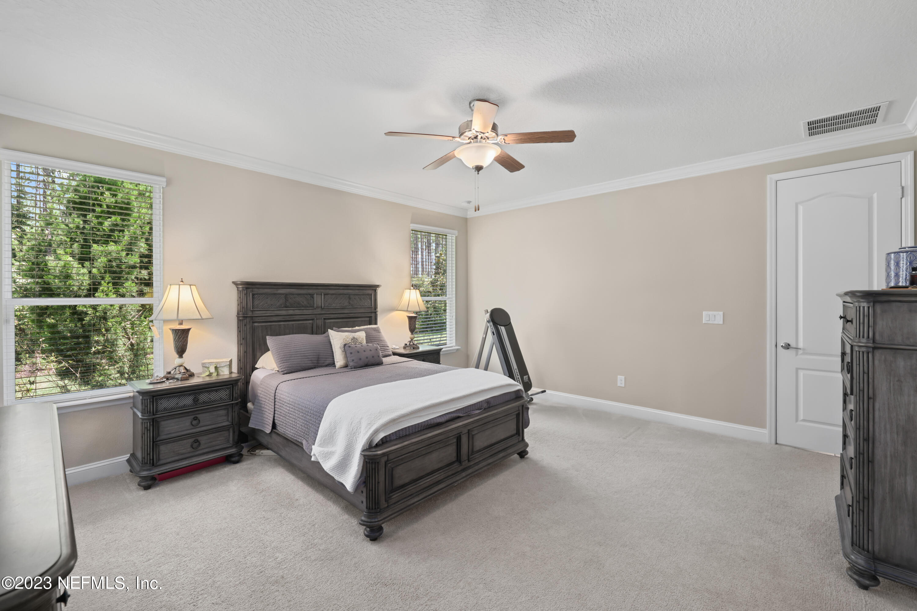 370 Coco Point St. Augustine, FL 32092 - Photo 19 of 48 a spacious bedroom with a bed and a window