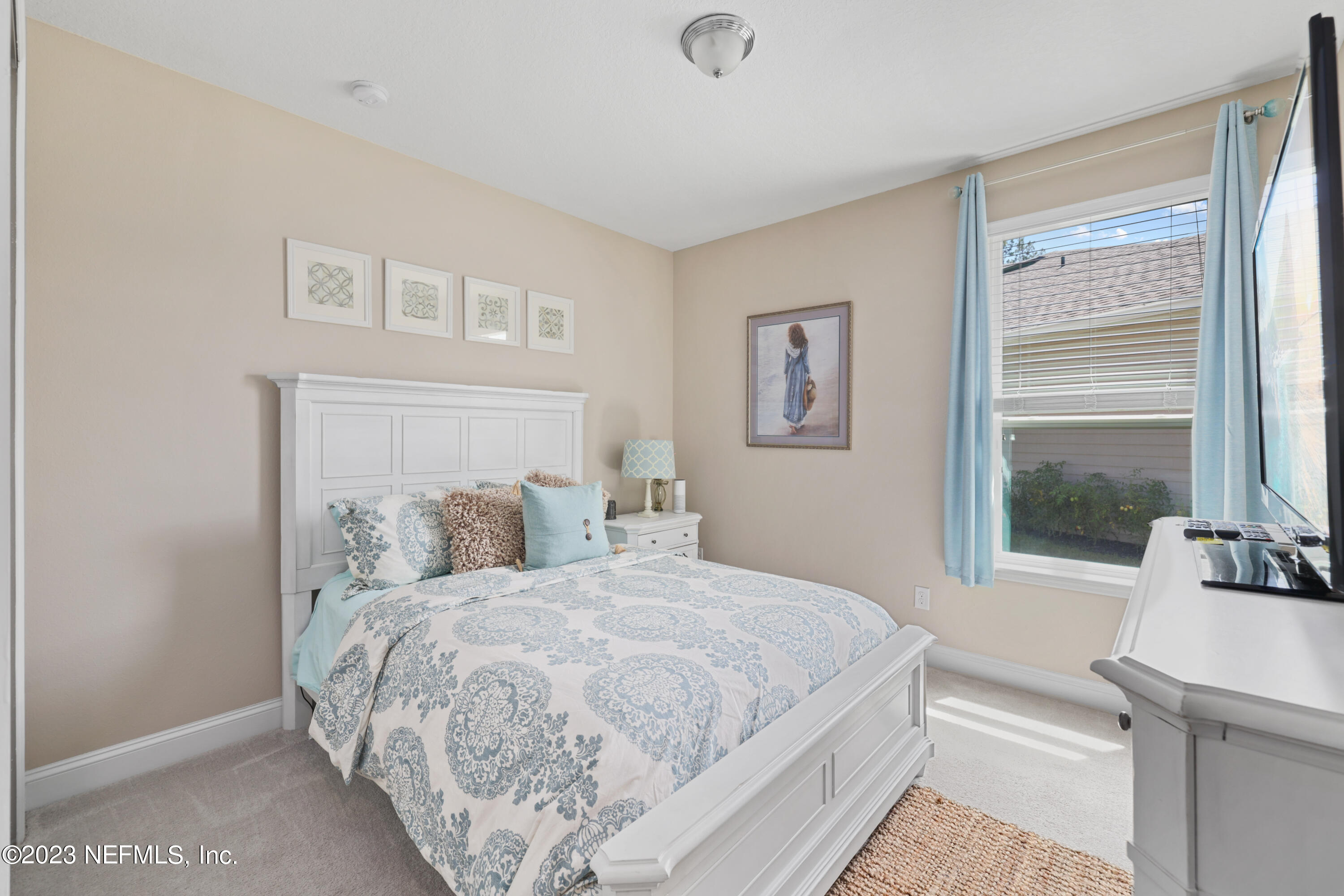 370 Coco Point St. Augustine, FL 32092 - Photo 25 of 48 a bedroom with a large bed and a large window