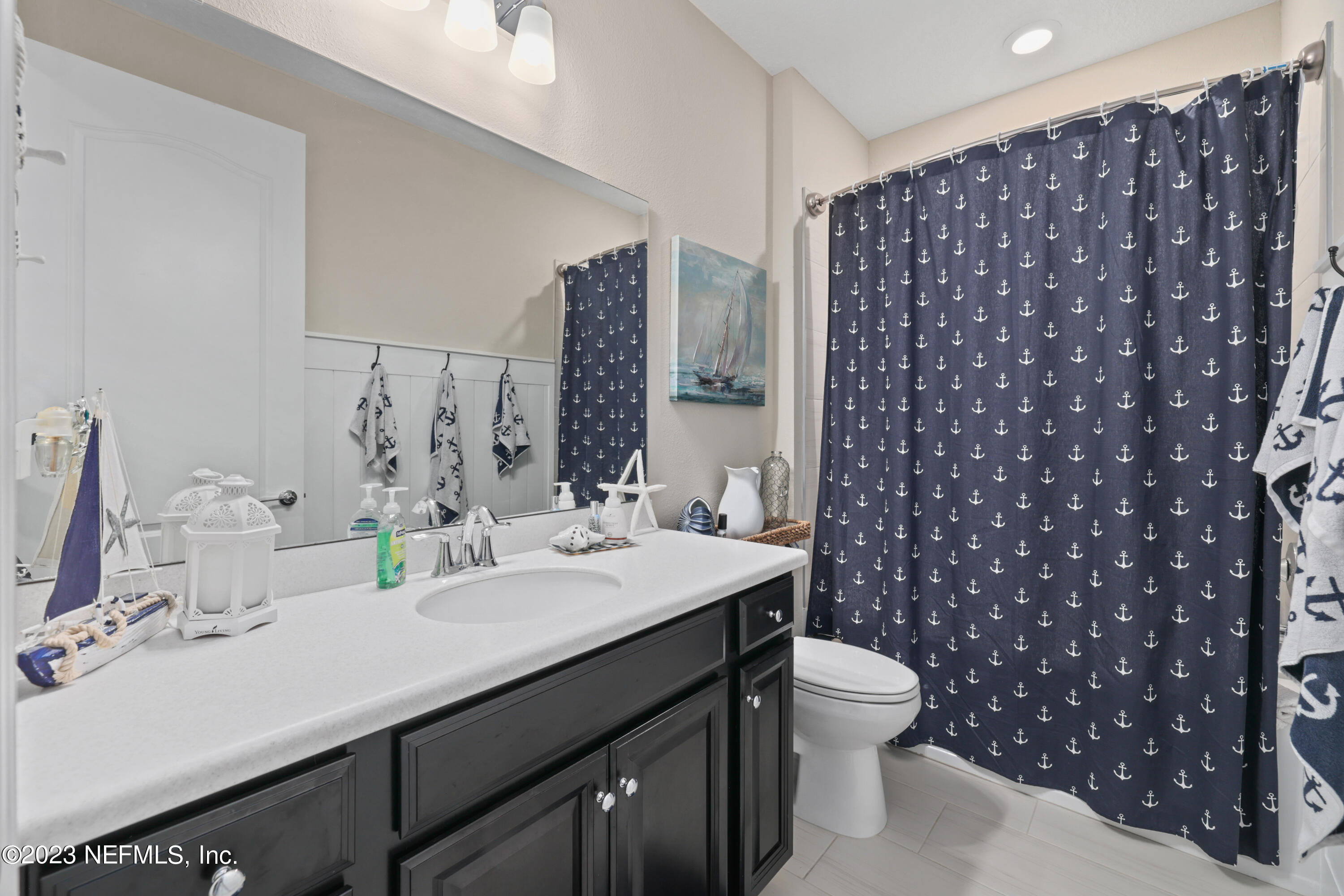 370 Coco Point St. Augustine, FL 32092 - Photo 29 of 48 a bathroom with a sink a toilet and shower curtain