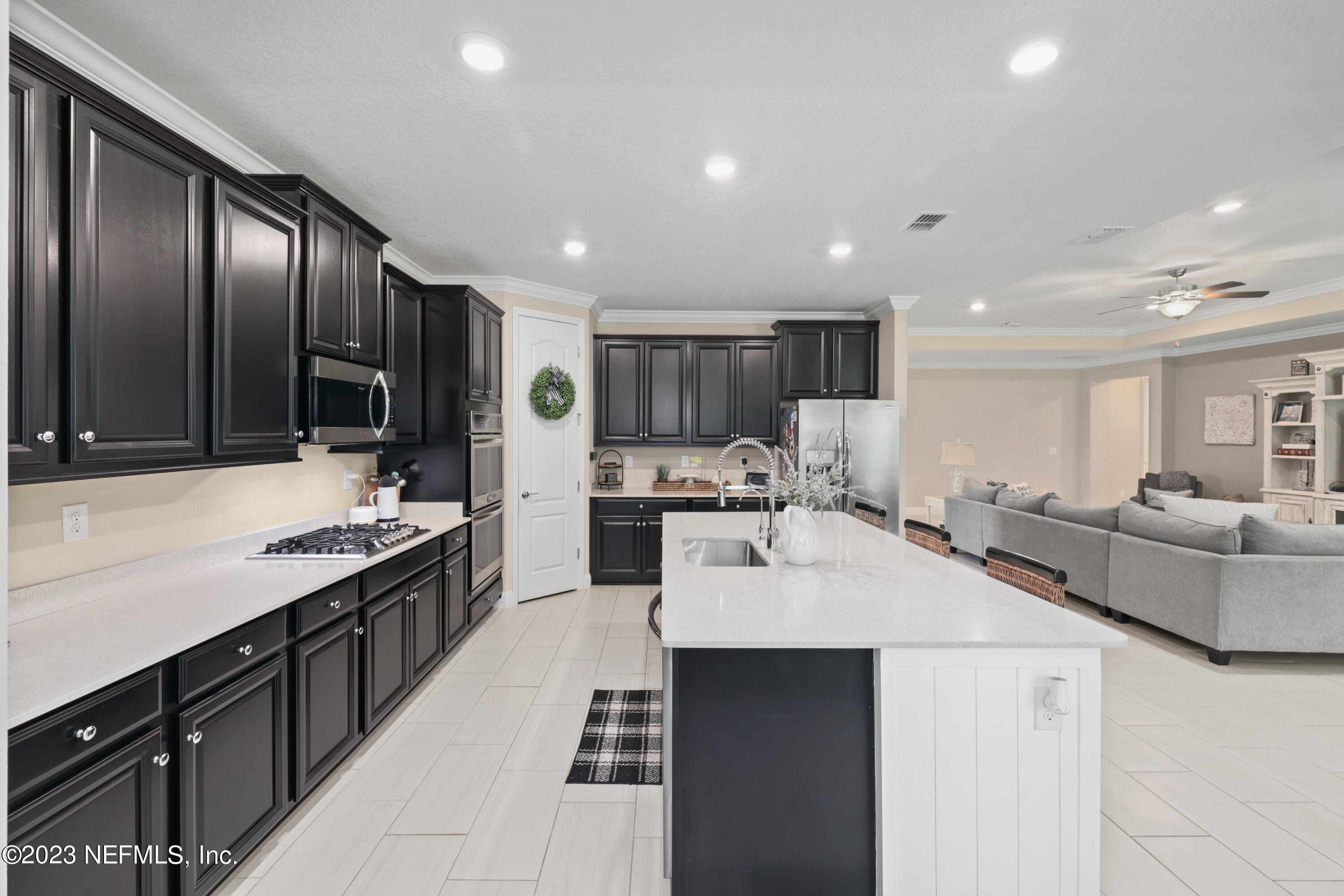 370 Coco Point St. Augustine, FL 32092 - Photo 10 of 48 a large kitchen with stainless steel appliances kitchen island granite countertop a large counter top a stove and a sink