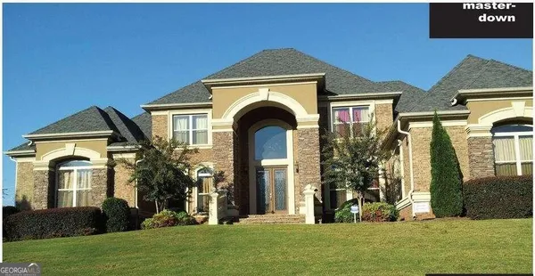 a front view of a house with a yard