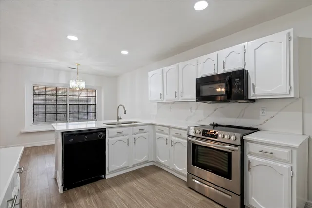 a kitchen with stainless steel appliances granite countertop a stove and a sink