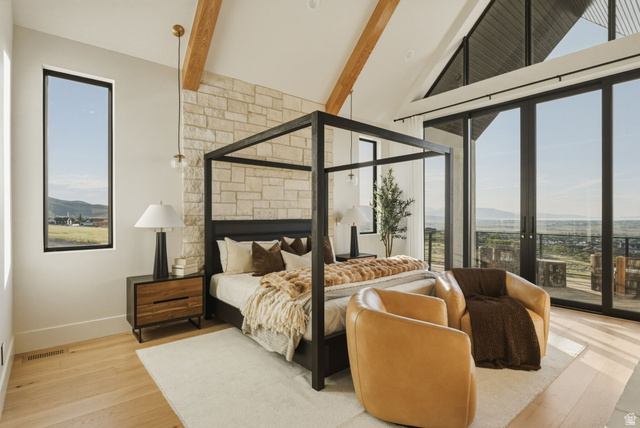 923 North Emery Lane Elk Ridge, UT 84651 - Photo 25 of 101 Vaulted ceiling bedroom featuring exposed wood beams, a stone accent wall, and expansive glass doors opening to the exterior