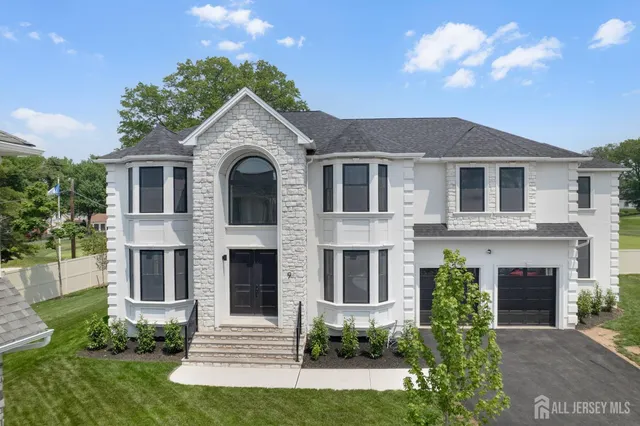 an aerial view of a residential houses with outdoor space