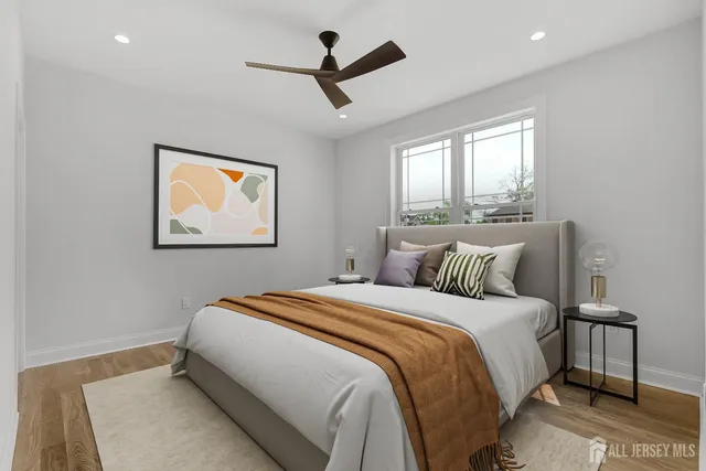 a view of a hallway with wooden floor and windows