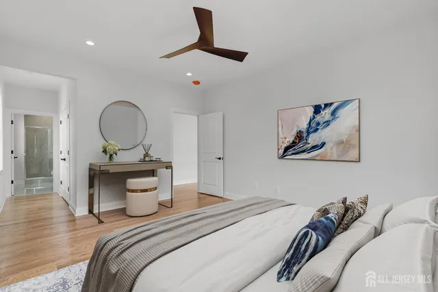 a spacious bathroom with a double vanity sink mirror and bathtub