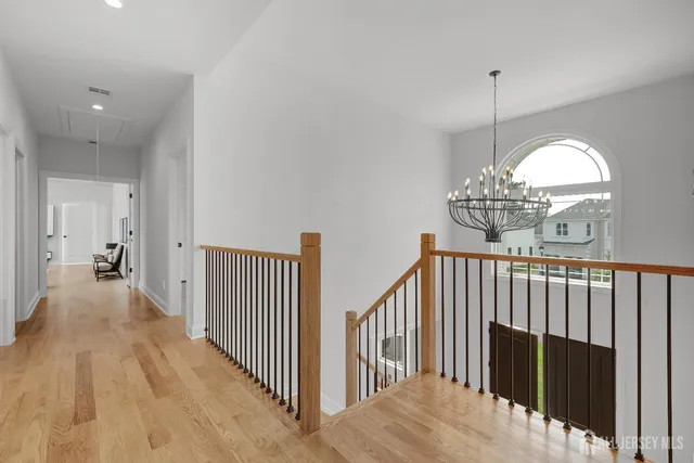 a spacious bedroom with a bed a couch and large windows