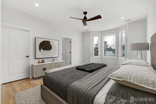 a living room with furniture a ceiling fan and a rug
