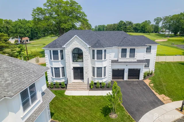 a view of a hallway with wooden floor and windows