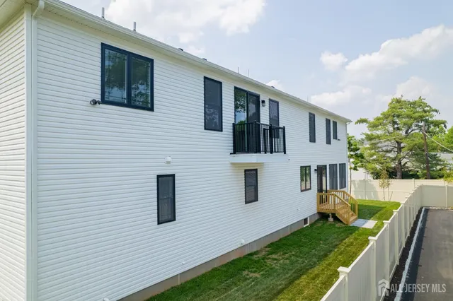 a kitchen with stainless steel appliances a sink wooden floor and stove